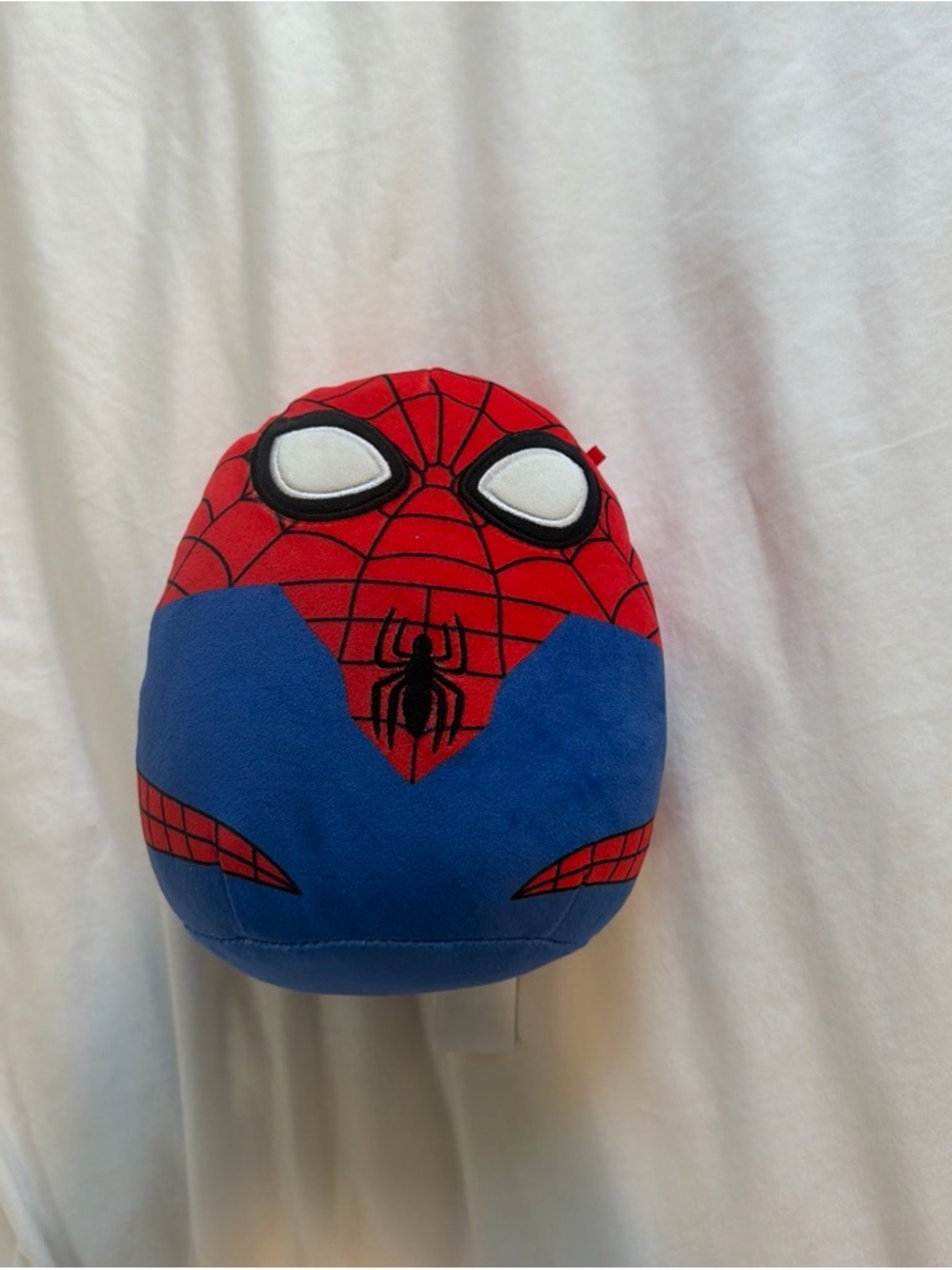 Spider-Man plush egg with red and blue suit with black web pattern